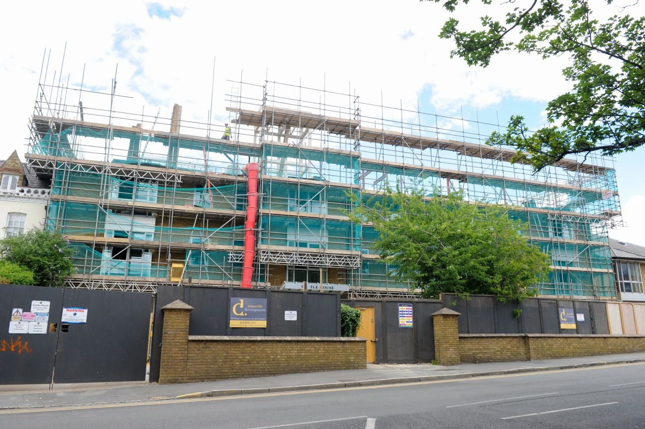 Castle House from the street, the existing building under scaffold with the rooftop extension above