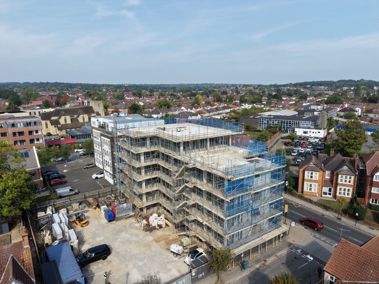 Aerial view from the south showing the full height of the frame above the surrounding roofs