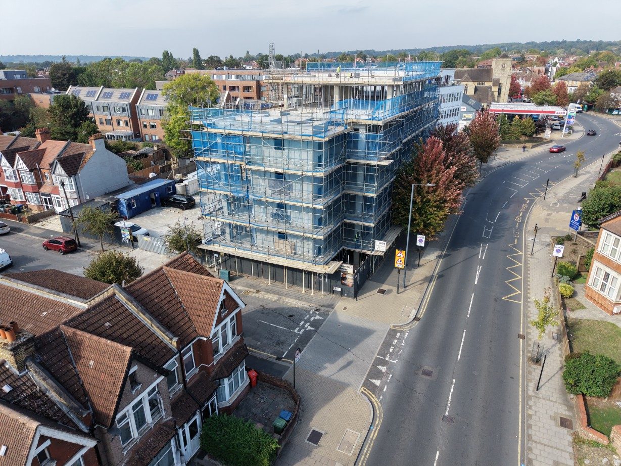 The corner of the building at the road junction, with scaffold wrapped around both elevations