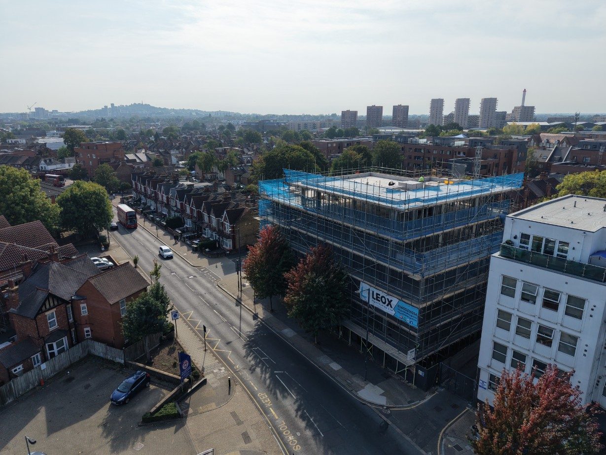 Aerial view along Harrow High Street with the development mid-frame and tower blocks on the horizon