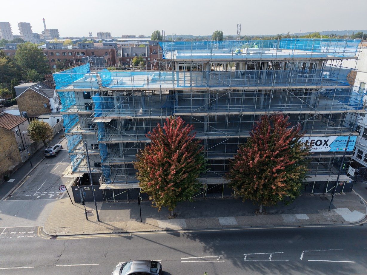 The high street frontage of the site seen over the street trees